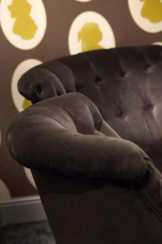 a close up of the arm of a couch at Le Mireille in Paris