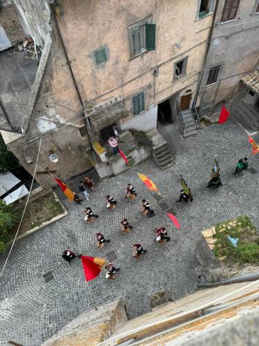 a group of people standing in a courtyard with umbrellas at la Contessa in Mazzano Romano