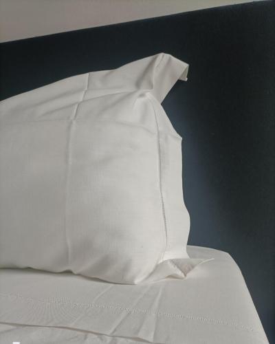 a white pillow sitting on top of a bed at la Contessa in Mazzano Romano