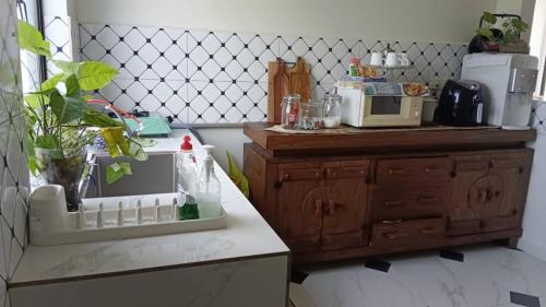 a kitchen with a counter with a microwave on it at Villa Kamila in Mersing