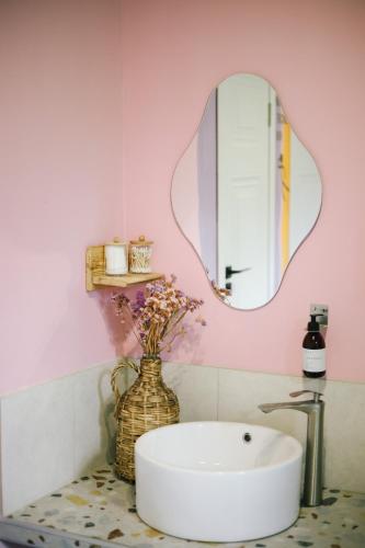 a bathroom with a sink and a mirror at Buna Guest House in Gyumri