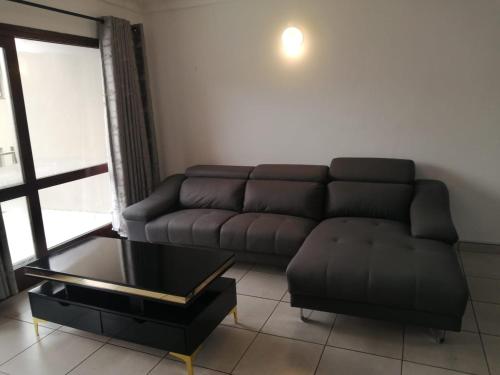 a living room with a couch and a coffee table at Corona Del Mar 7 in Margate