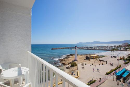 a view of a beach and the ocean from a balcony at JS Miramar in Can Picafort