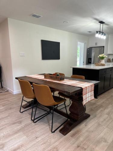 a kitchen with a table and chairs in a room at Hillside House Room 2 in Tyler