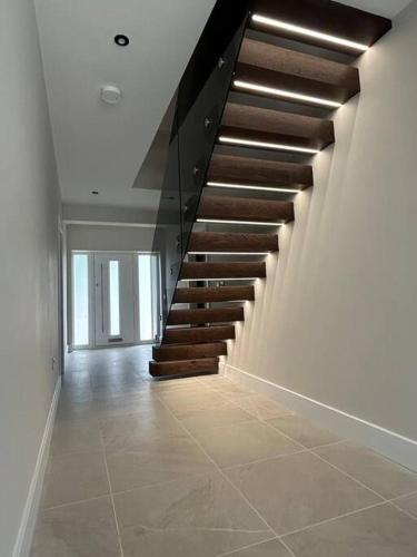 a hallway with a staircase in a house at York Fields Retreat - 4 Ensuite Bedrooms in York