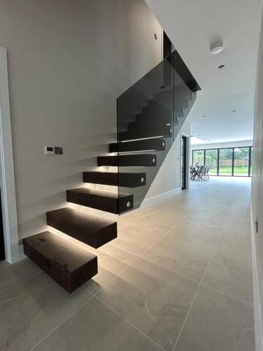 a staircase in a house with a bench in a room at York Fields Retreat - 4 Ensuite Bedrooms in York