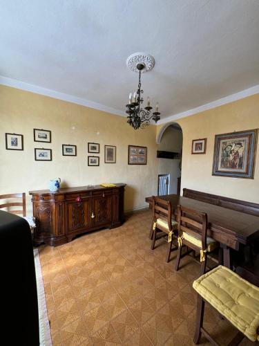 a living room with a wooden table and benches at Micheli Suite Anfiteatro Square in Lucca