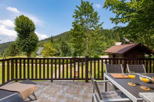 a patio with a table and chairs and a gazebo at Gorska bajka - Smreka, kuća za odmor i wellness in Stara Sušica