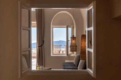 a view of a living room through a window at La Maltese Estate in Imerovigli