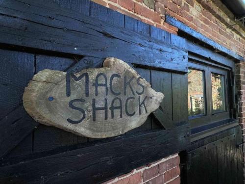 a sign on the side of a brick building at Macks Shack at Machrimore in Wells next the Sea