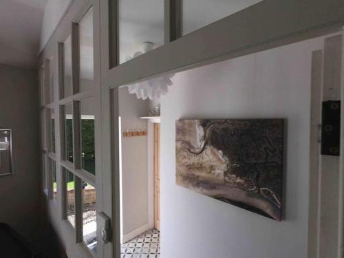 a hallway with a painting hanging on the wall at Macks Shack at Machrimore in Wells next the Sea