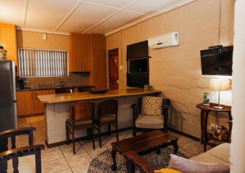 a kitchen with a counter and chairs in a room at Fossil Hills in McGregor