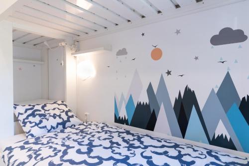 a bedroom with a mountain mural on the wall at Na Obláčku in Benecko