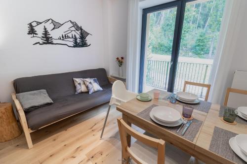 a living room with a table and a couch at Na Obláčku in Benecko