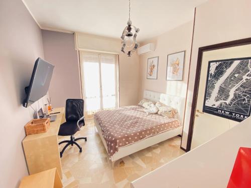 a bedroom with a bed and a desk and a tv at Milano Relax Room in Brugherio