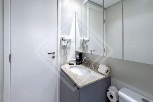a bathroom with a sink and a mirror at Zainalofts7Vila Mariana ao lado metrô, CASV 66/102/103 in Sao Paulo