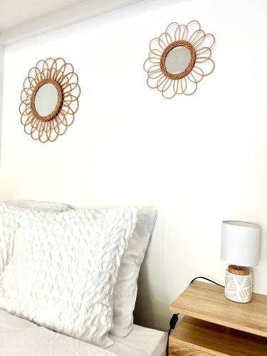 - une chambre avec un lit et deux miroirs sur le mur dans l'établissement Cocon des Alouettes, à Montmorency