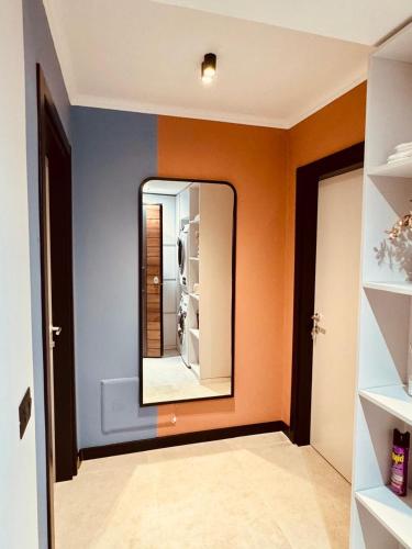 a hallway with a mirror on a wall at Lili's Tirana Center Apartments in Tirana