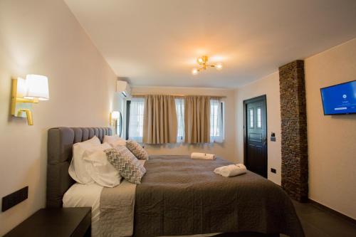 a bedroom with a bed with pillows on it at Berat River House Boutique Hotel in Berat