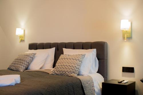 a bedroom with a large bed with two pillows at Berat River House Boutique Hotel in Berat