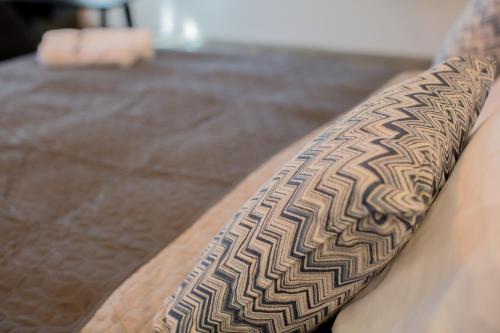 a brown and white patterned arm of a couch at Berat River House Boutique Hotel in Berat