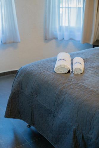 a bedroom with a bed with two towels on it at Berat River House Boutique Hotel in Berat