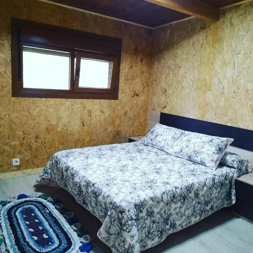 a bedroom with a bed and a window at A Corcheira in Pontevedra