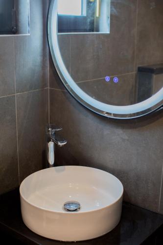 a white sink in a bathroom with a mirror at Berat River House Boutique Hotel in Berat