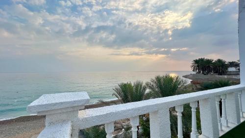 a view of the ocean from a balcony at Wadi shab Beach Resort in Sur