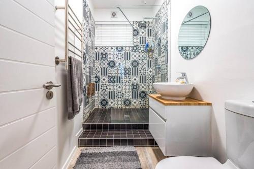 a bathroom with a sink and a shower at Urban Retreat in the heart of Green Point in Cape Town