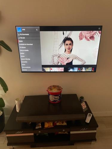 a flat screen tv on a wall with a table at Juliette apt with private garden in Korçë