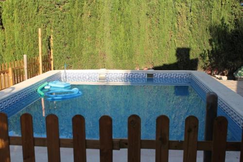 a swimming pool with a frisbee in it at La Casa del Olivo en Montserrat - Valencia in Valencia