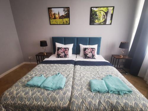 a bedroom with a bed with two pillows on it at Under the Hill plus in Bad Muskau