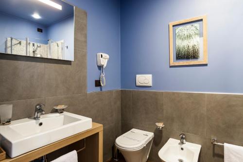 a bathroom with a sink and a toilet at Best Western Hotel Santa Caterina in Acireale