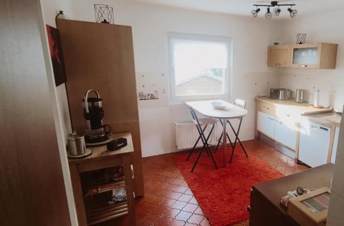 a small kitchen with a small table and a window at Haus Helga in Albersweiler