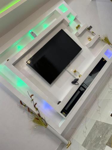 a flat screen tv sitting on top of a table at HKB Serviced Apartments in Odo Ona