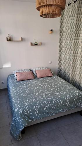 un lit avec deux oreillers dessus dans une chambre dans l'établissement Super studio, proche centre ville, à Rochefort