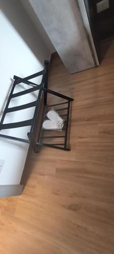 a metal rack with a white shirt on a wooden floor at Regina di Puglia in Santeramo in Colle