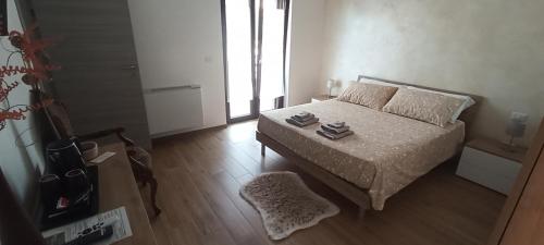 a bedroom with a bed and a table with books on it at Regina di Puglia in Santeramo in Colle