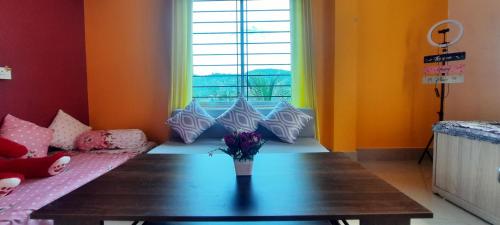 a living room with a table and a couch at Selfie n Studio Homestay in Khānāpāra