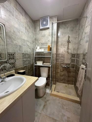 a bathroom with a shower and a toilet and a sink at Camelgila Appartment Royal Residence in Port Ghalib