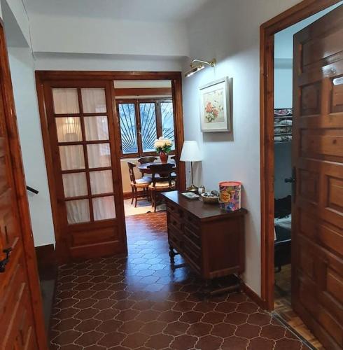 a room with a desk and a dining room with a table at Casa Los Quinos in Bielsa