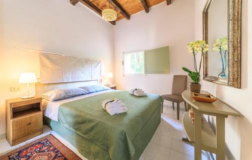 a bedroom with a bed and a table and a mirror at Domus Colonnato su Villa d'Este in Tivoli