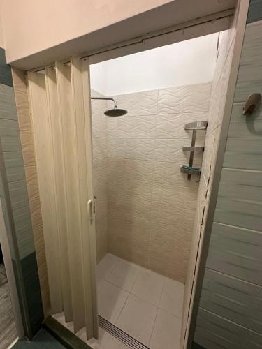 a walk in shower with a glass door in a bathroom at Comfort Guest Rooms in Plovdiv