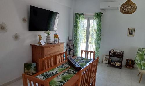 a living room with a television on the wall at MarGeo View House in Mpatsi, Andros in Batsi