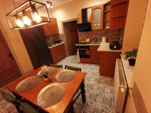 a kitchen with a wooden table with plates on it at Gościniec Trzebiel in Trzebiel