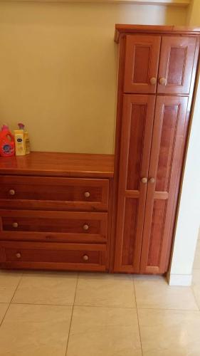 a wooden dresser in a corner of a room at Island Paradise in The Valley