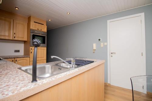 a kitchen with a sink and a counter top at City Breeze in Ostend