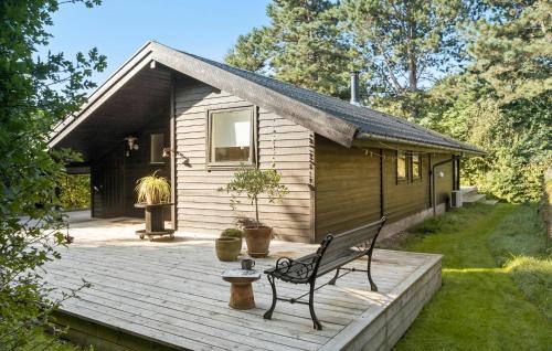 a house with a bench on a wooden deck at Awesome Home In Føllenslev With Wifi in Føllenslev