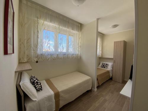 Postel nebo postele na pokoji v ubytování Albergo Lodrino